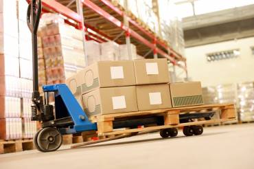 forklift at the base of a warehouse floor signifying warehousing in logistics