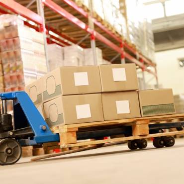 forklift at the base of a warehouse floor signifying warehousing in logistics